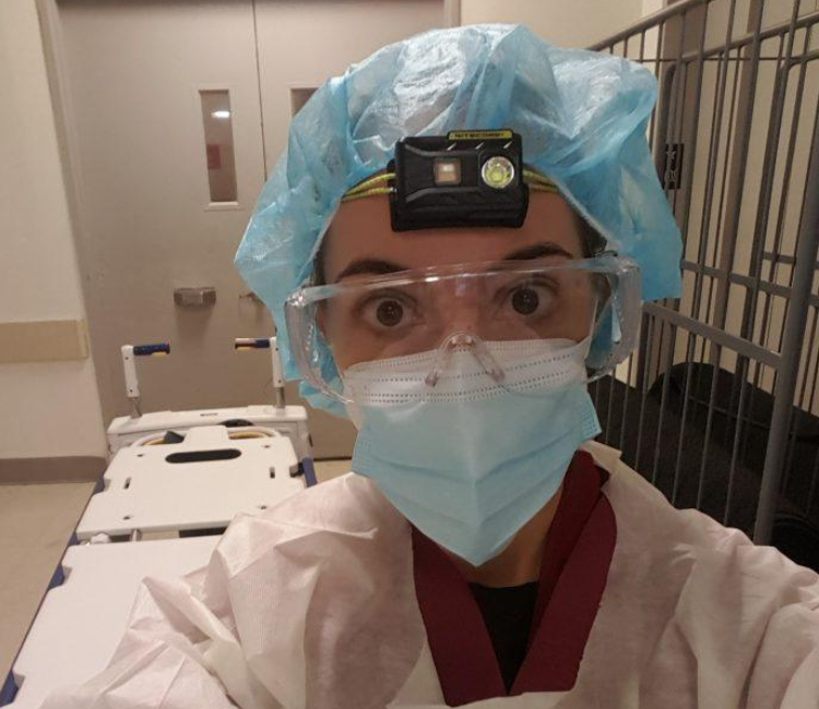 A picture of Adrienne in personal protective equipment volunteering to help during COVID